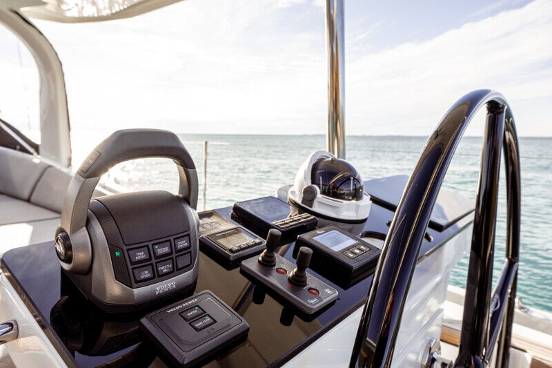 Jeanneau Yachts 65 veneilemässä trooppisessa ympäristössä, palmut taustalla.