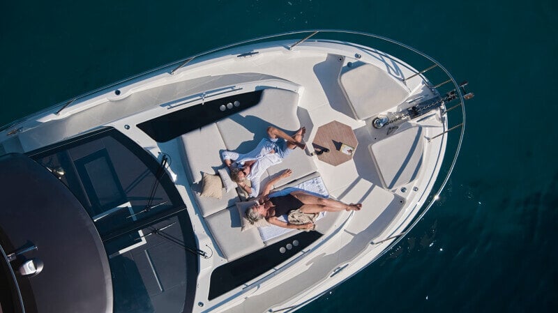 Prestige F5.7 moored at a luxury dock with elegant lines and modern styling.