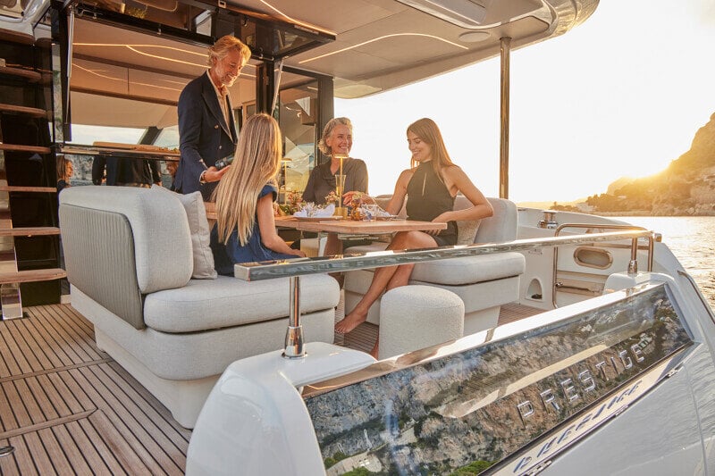 Aft deck of the Prestige F5.7 yacht with a stylish dining setup.