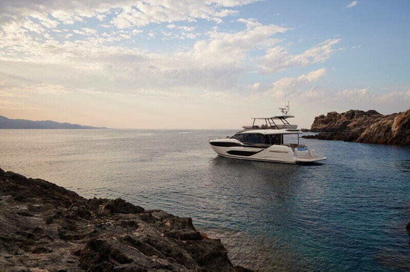 Prestige F5.7 moored at a luxury dock with elegant lines and modern styling.